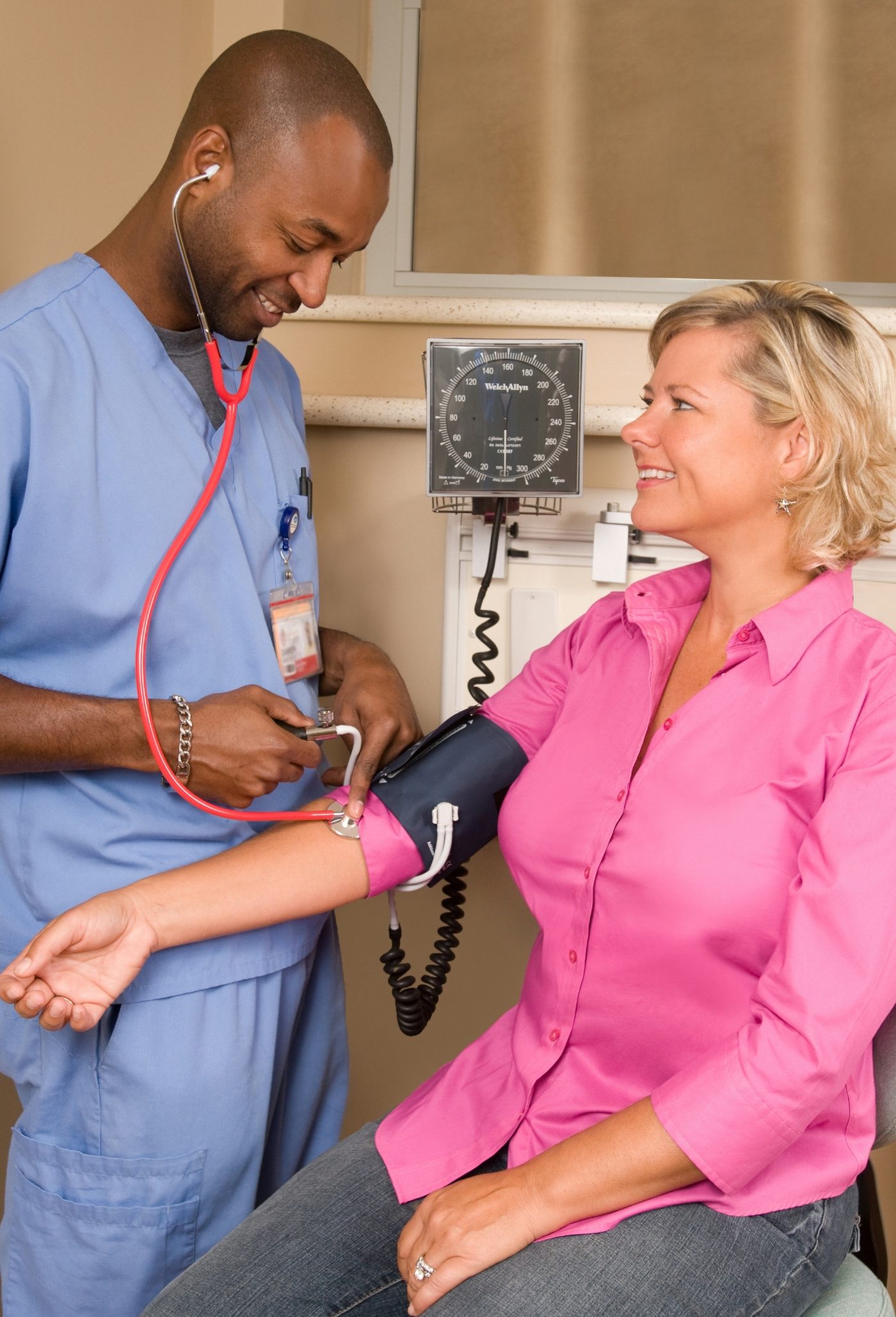 Community health screening — a clinician checking a patient's blood pressure